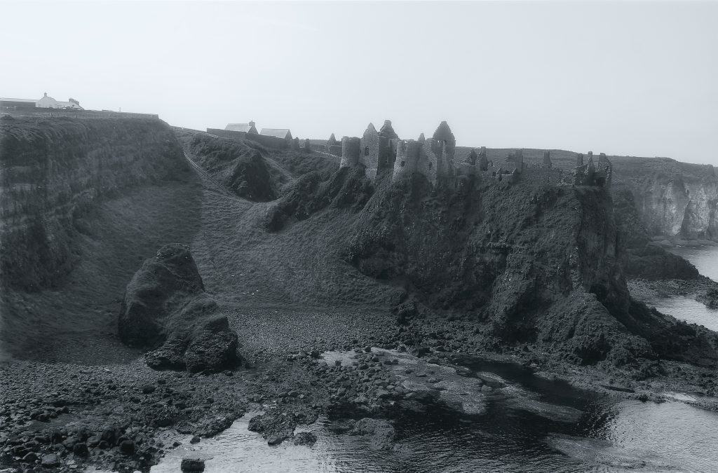 a black and white photo of a rocky coastline