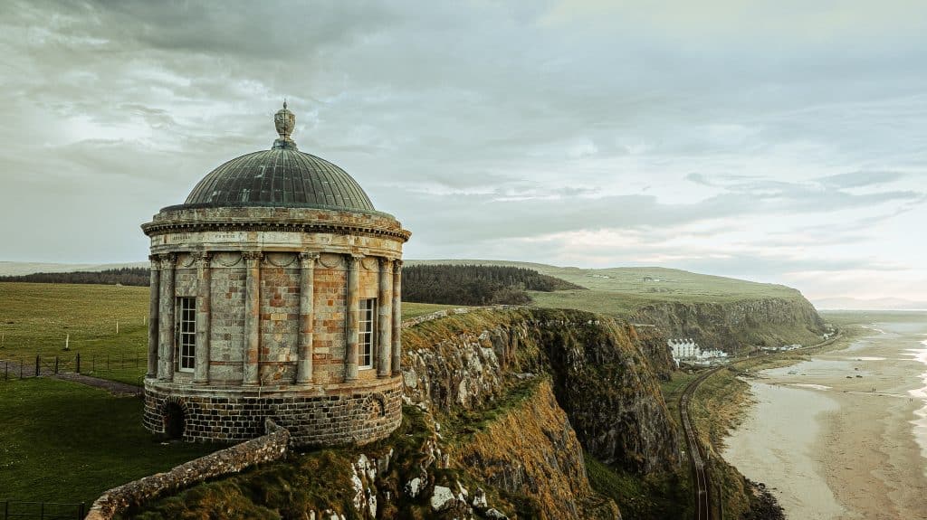 Classic architectural library on the edge of a cliff overlooking the coastal beach at dusk