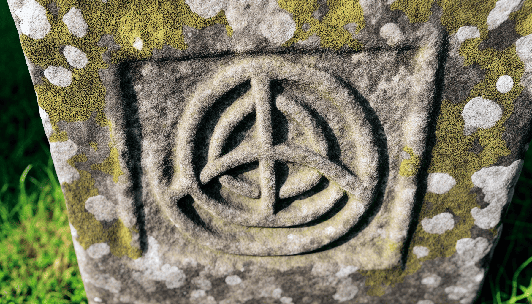Ancient stone carving with a Triquetra symbol, representing interconnectedness and the power of three